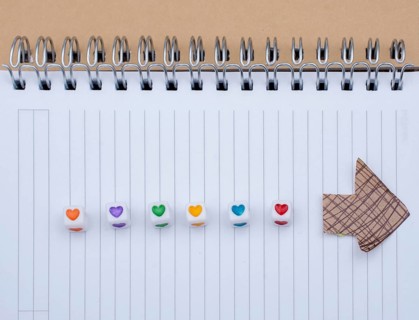 Love cubes and paper arrow on a notebook on canvas