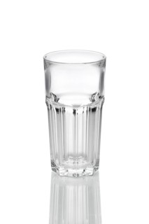 Empty transparent faceted glass with reflection on white background