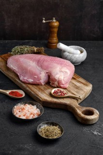 Raw fresh turkey boneless breast without skin on dark background