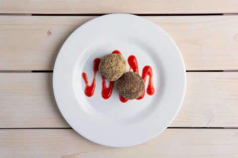 Chocolate truffles with biscuit powder. Rum balls and raspberry jam. Top view