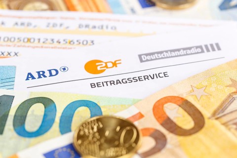 Contribution service of ARD and ZDF Rundfunkgebuehr GEZ with money in Stuttgart