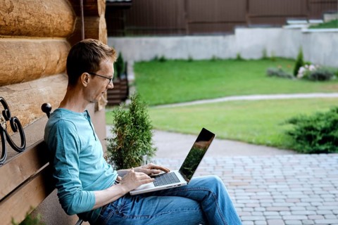 Middle aged man making video call outdoors