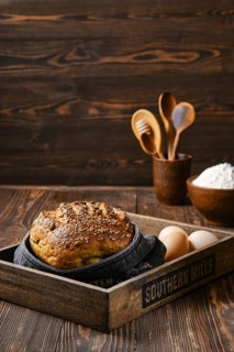 Fresh oats bread with sunflower seeds and sesame on wooden table