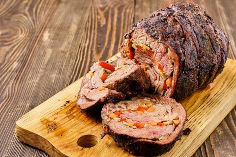Closeup view of baked beef roll with vegetables