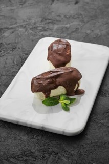 Glazed curd with chocolate on marble plate