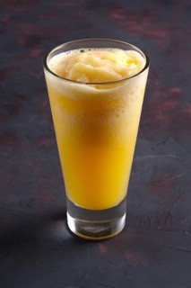 Glass of orange granizado. Crushed ice with fruit syrup beverage
