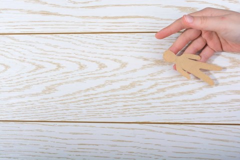 Man shape cut out of paper in hand in the view