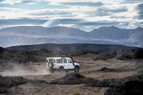 White Land Rover on a dirt road