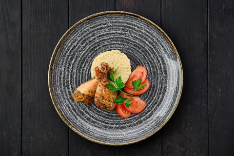 Top view of fried chicken leg with millet porridge