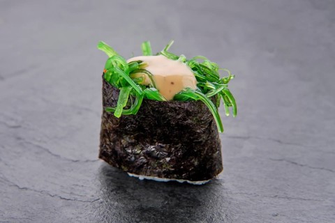 Macro photo of pickled seaweed with nut sauce