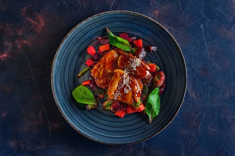 Top view of roasted pike served with beetroot
