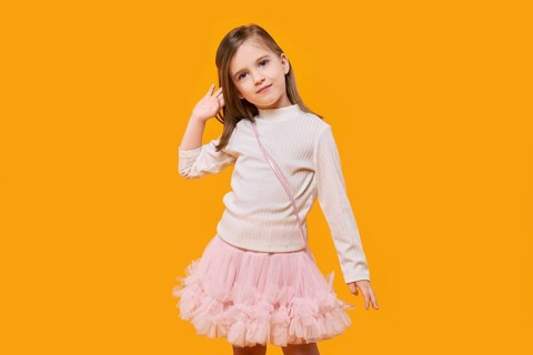 Cute little child posing on bright yellow background