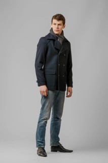 Full length portrait of handsome man in warm winter coat posing in studio