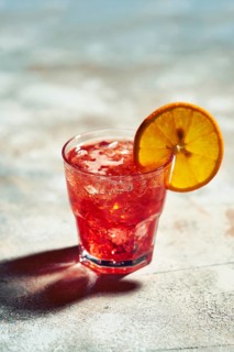 Cocktail boulevardier under sunlight with harsh shadows
