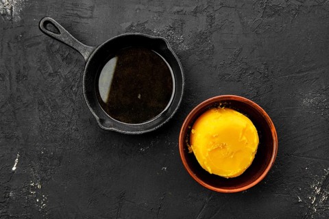Homemade rustic melted butter and small cast iron skillet