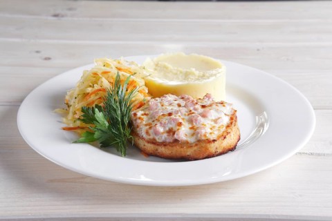Fish cutlet with ham and melted cheese topping served with pickled cabbage and mashed potato