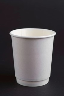 Cardboard cup without lid on dark background