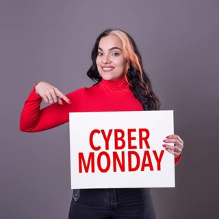 Beautiful woman pointing at a Cyber Monday sign. Commercial concept. Commerce
