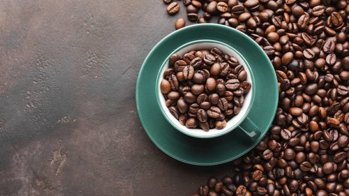 Cup filled with organic coffee beans