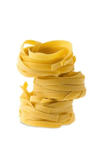 Nest noodles isolated on white background. Italian tagliatelle with egg