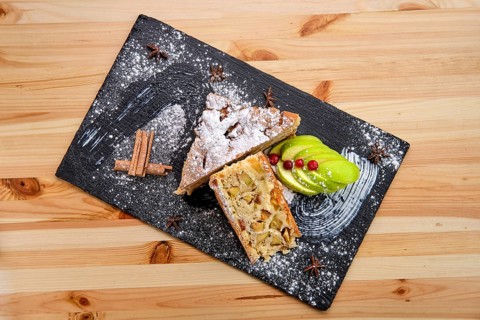 Apple pie on slate plate top view