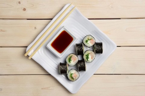 Top view of plate with shrimp rolls with hashi and siy sauce
