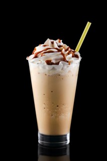 Caramel milkshake isolated on black background