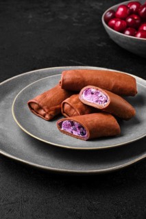 Thin chocolate pancakes stuffed with curd
