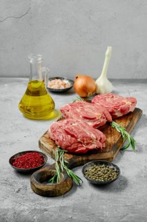Raw fresh lamb neck cut on slices with spice and herbs