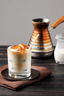Iced latte with frozen coffee cubes and sweet cream