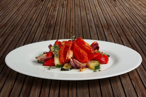 Grilled vegetables on white plate cutted on slices