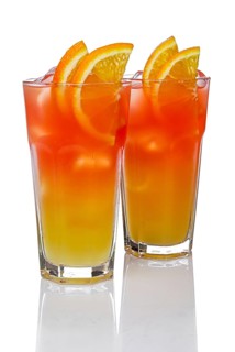 Two highball glasses with Juicy Orange and Red Tequila Sunrise cocktail with reflection isolated on white