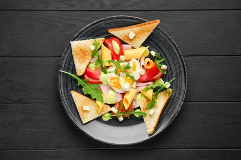 Overhead view of boiled eggs with slices of toast