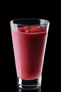 Glass of strawberry smoothie isolated on black background