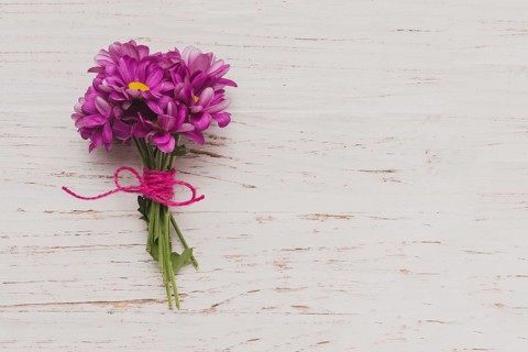 Purple flowers tied white wooden surface. Resolution and high quality beautiful photo