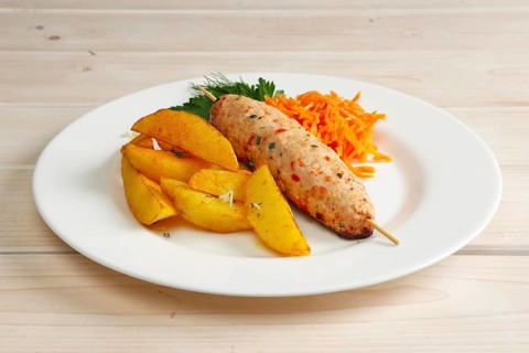 Kebab on skewer with fried potato and spicy carrot
