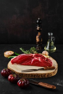 Raw top sirloin beef steak on wooden cutting board