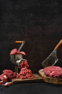 Making minced beef meat with oldfashioned meat grinder