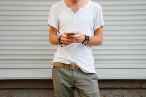 Unrecognisable man with mobile phone in hands. Addiction to technology