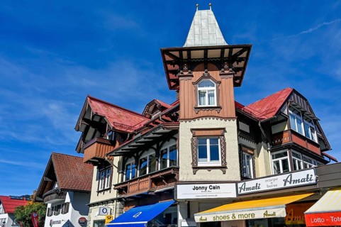 Pedestrian zone with classic wooden building with wooden shingle facade