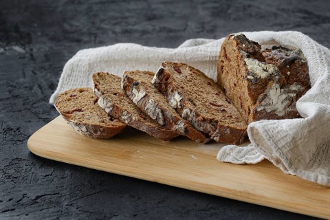 Artisan freshly baked broun bread with raisins cut on slices