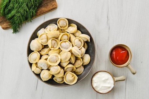 Top view of homemede meat dumplings on white wooden table