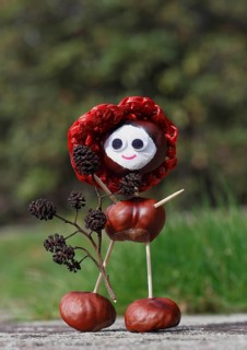 Chestnut figure with hat wearing black alder cones