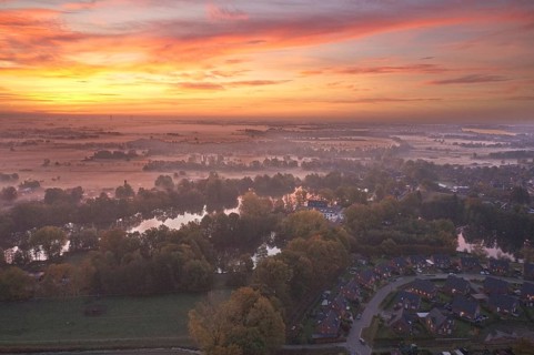 Aerial view of the landscape around Sandbraak Lake near Fuenfhausen in Hamburg's Kirchwerder district in autumnal morning atmosphere with light ground fog. In the foreground the residential area Fritz...