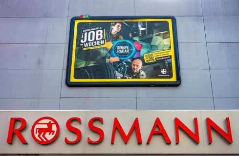 Large poster advertising the Bundeswehr on the wall of a Rossmann shop