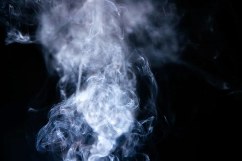 Blue smoke waves black background