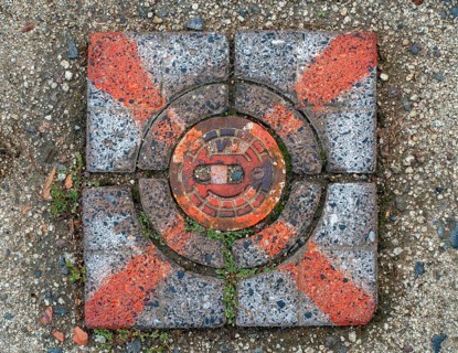 Red marked stone cover over a water hydrant connection