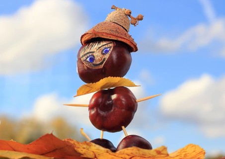 Smart chestnut figure with hat in the blue sky