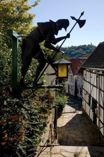 Half-timbered houses at the church steps with night watchman