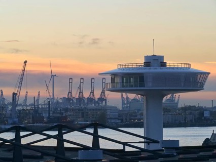 Lighthouse Zero on the Norderelbe in Hamburg's Hafencity against the backdrop of the container terminals and harbour cranes. Harbour